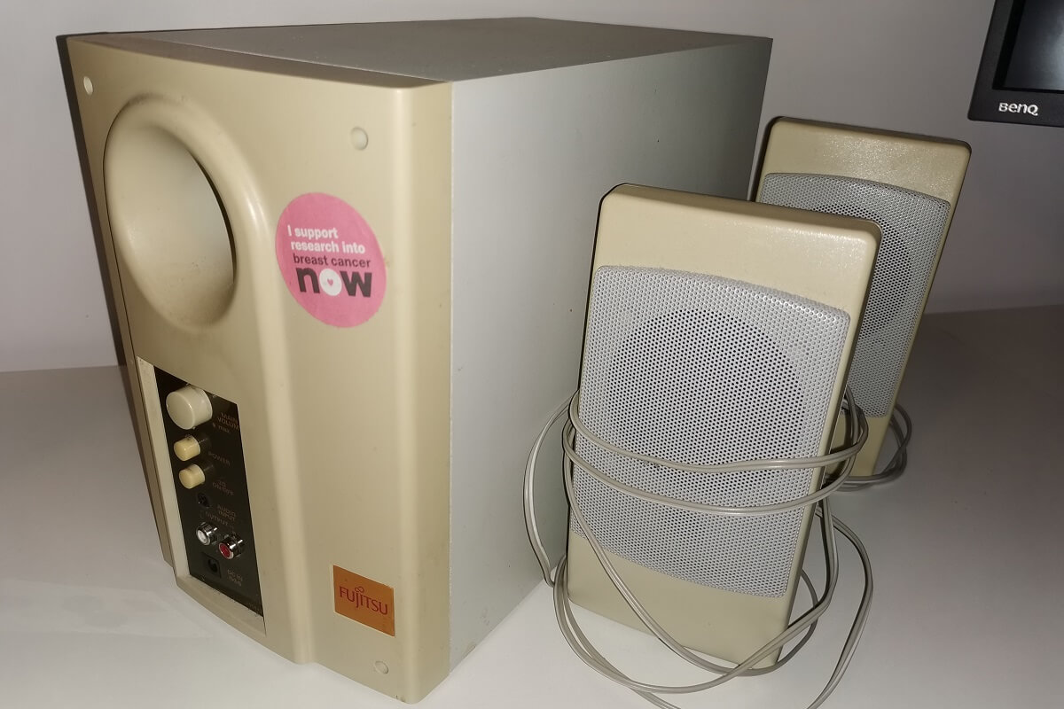 Fujitsu subwoofer and accompanying speakers on a desk